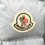 Light blue puffer jacket with embroidered Moncler logo patch on chest