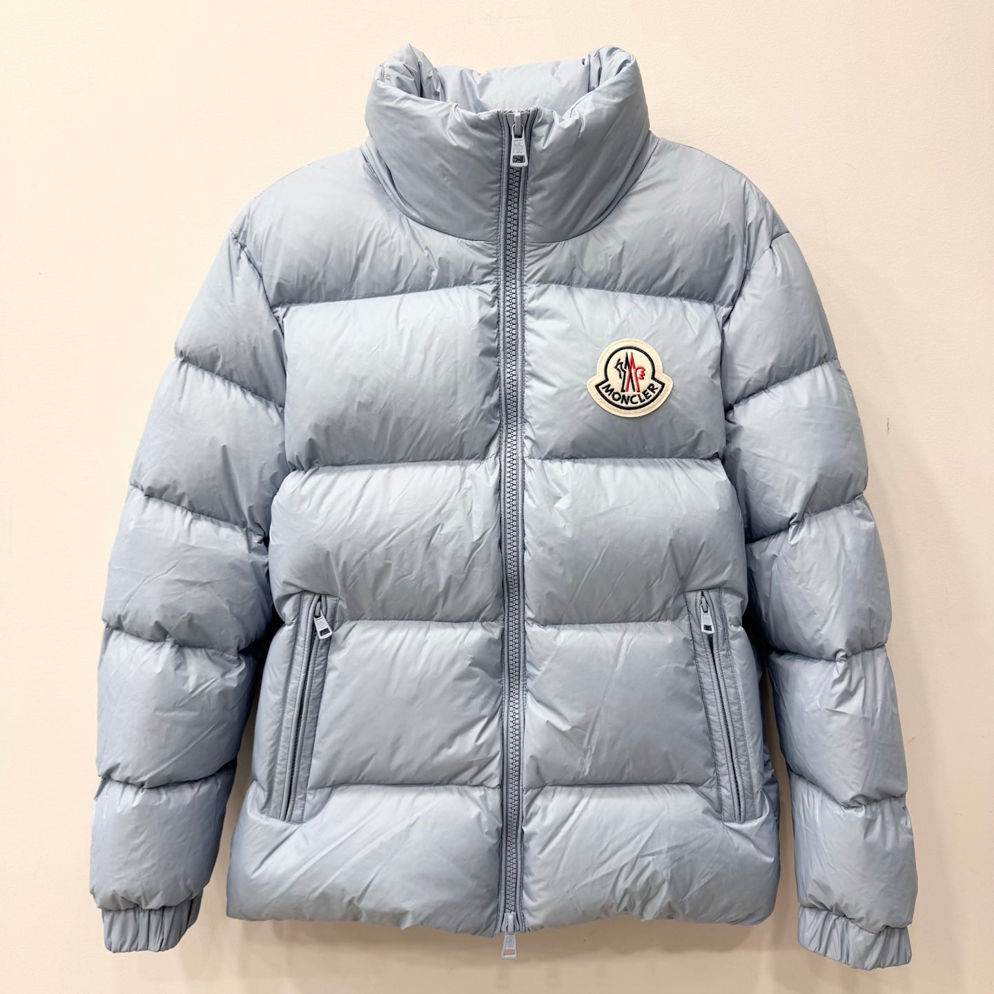 Light blue long puffer jacket with full-zip front and stand collar
