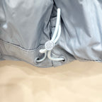 Light blue puffer jacket hem with gray drawstring toggles