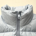 Light blue puffer jacket close-up with full-zip seam and quilted front sections