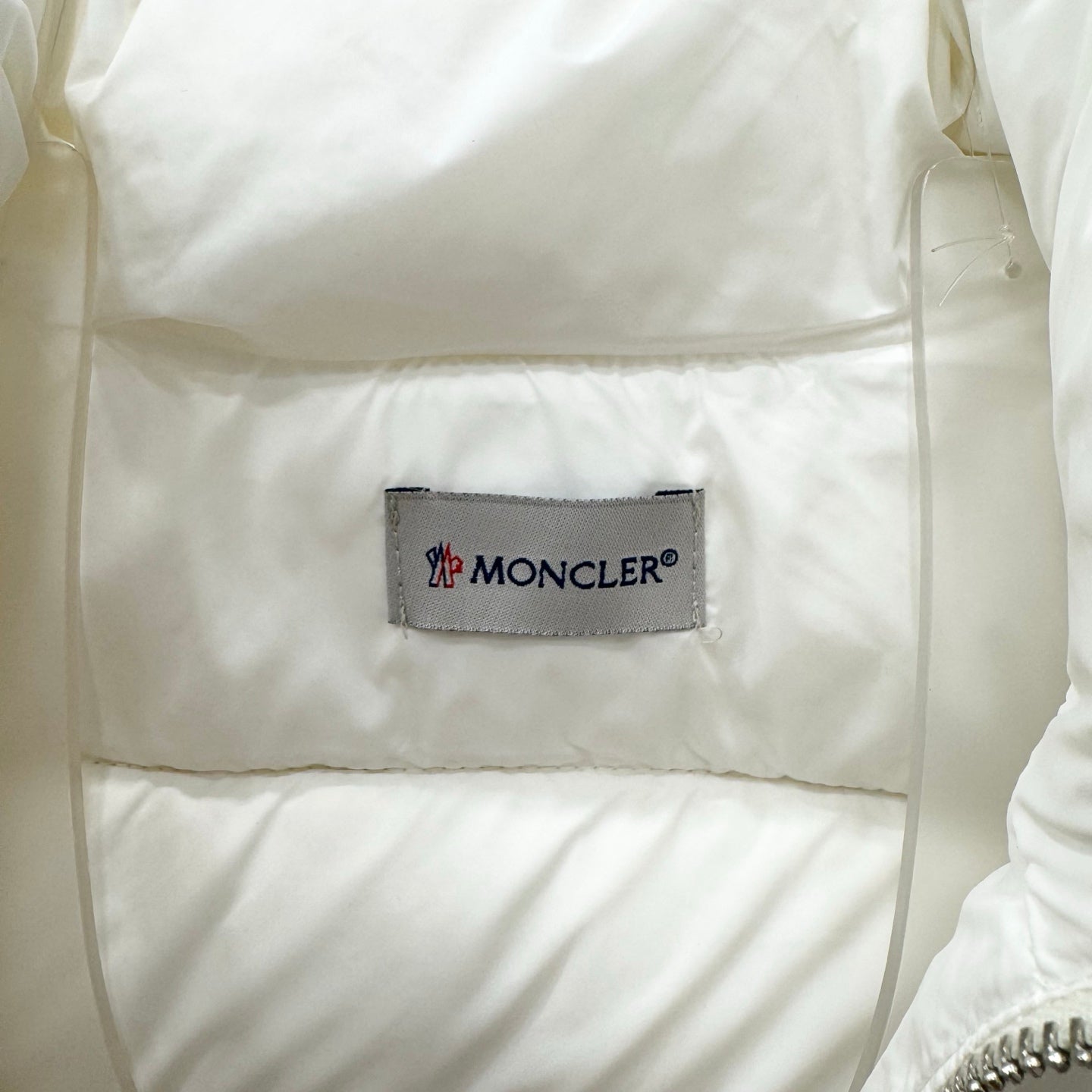 White puffer jacket interior with Moncler logo brand label