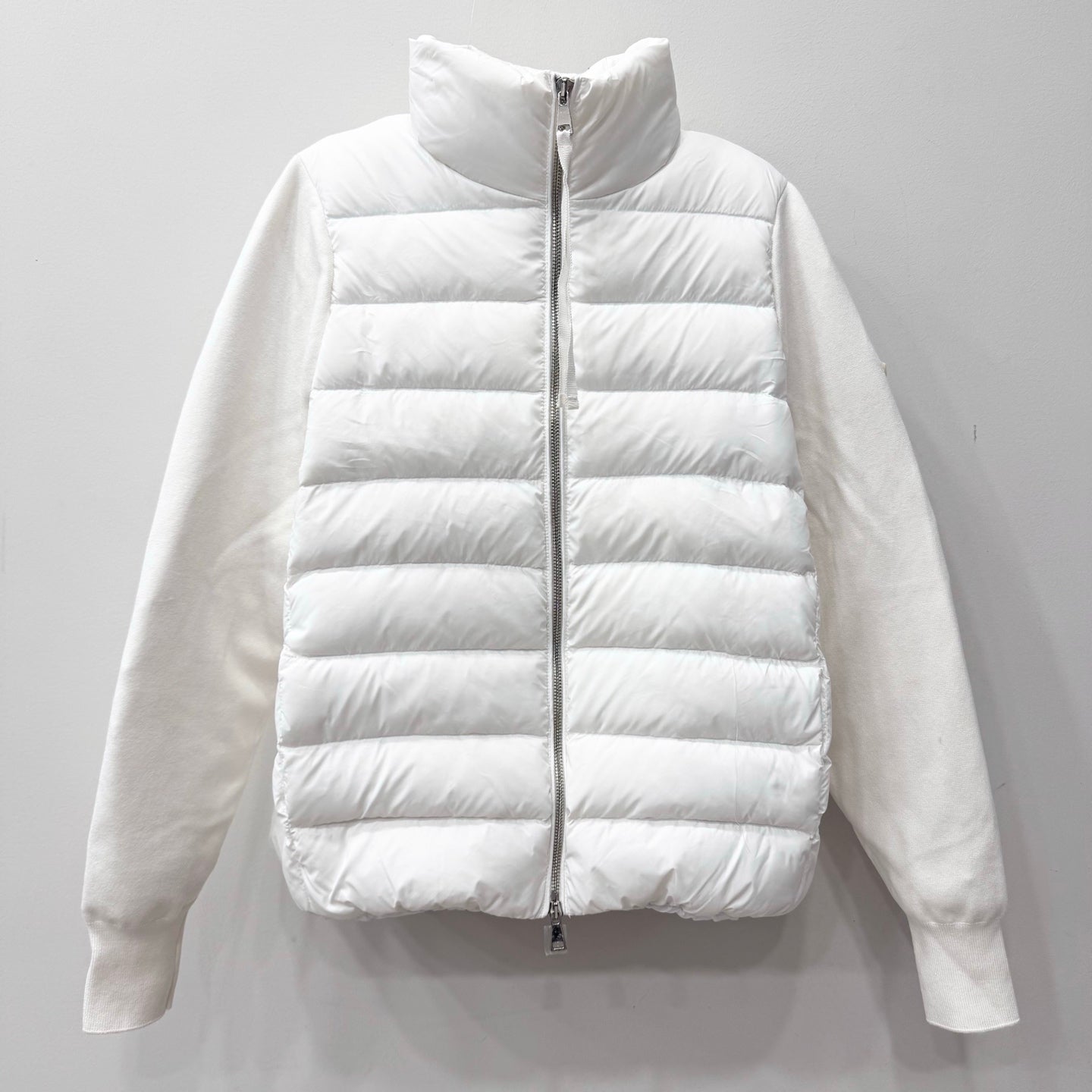 White long puffer jacket with zip front and quilted horizontal baffles