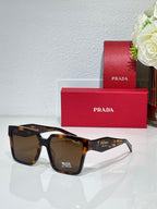 Prada sunglasses with dark lenses and tortoise-brown frame