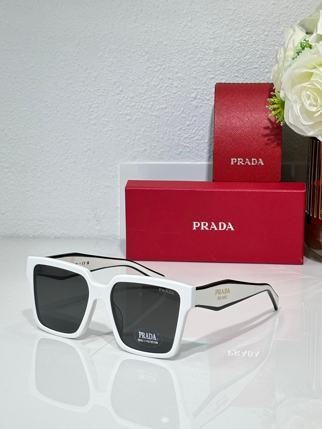 Prada sunglasses with white frame and tinted dark lenses