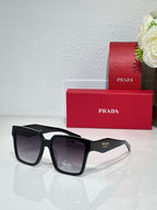 Prada sunglasses with black frame and tinted dark lenses