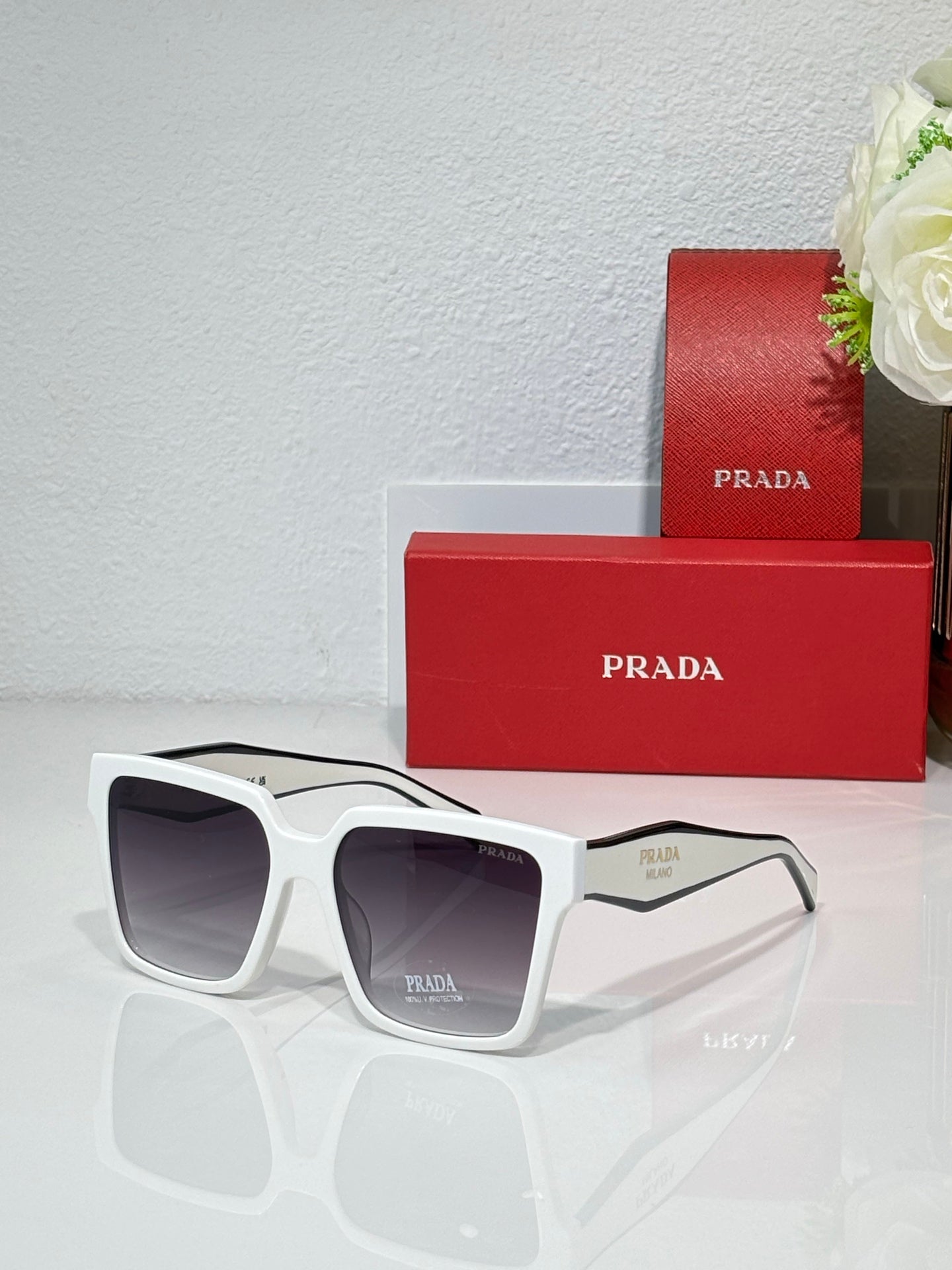 Prada sunglasses with white frame and dark lenses