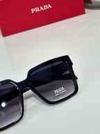 Prada sunglasses closeup with dark lenses and black frame