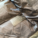Prada puffer jacket with care tags over quilted lining, tan and dark