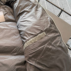 Prada puffer jacket side panel with front zipper and angled pocket, tan lining