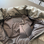 Prada puffer jacket interior with hang tags on quilted lining, tan and dark