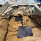 Beige puffer jacket interior with Prada hang tag and quilted fabric