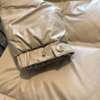 Beige puffer jacket sleeve cuff with snap button and quilted texture