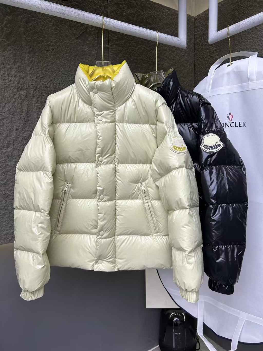 Cream puffer jacket with high neck and quilted panels, full sleeves.