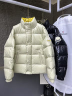 Cream puffer jacket with high neck and quilted panels, full sleeves.
