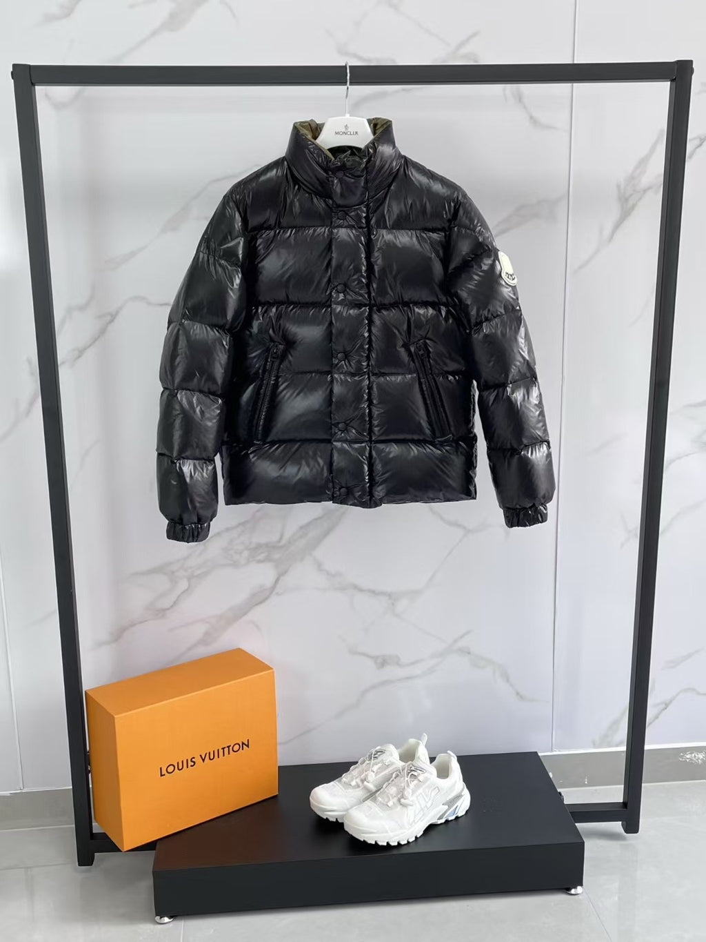 Black puffer jacket with high neck, quilted front, and full sleeves.