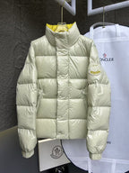 Cream puffer jacket with high neck, quilted design, and Moncler logo patch.