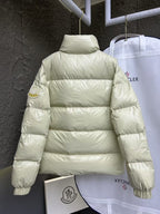 Cream puffer jacket back view with high neck and horizontal quilted stripes.