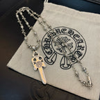 Silver-tone necklace with sword pendant and flower-studded chain on cloth pouch