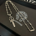Silver-tone necklace set with sword cross pendants and floral chain links on box