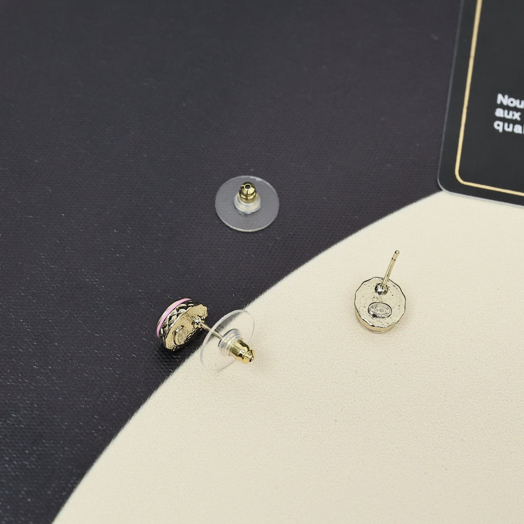 Gold-tone stud earrings with circular CC logo and pink enamel accents.