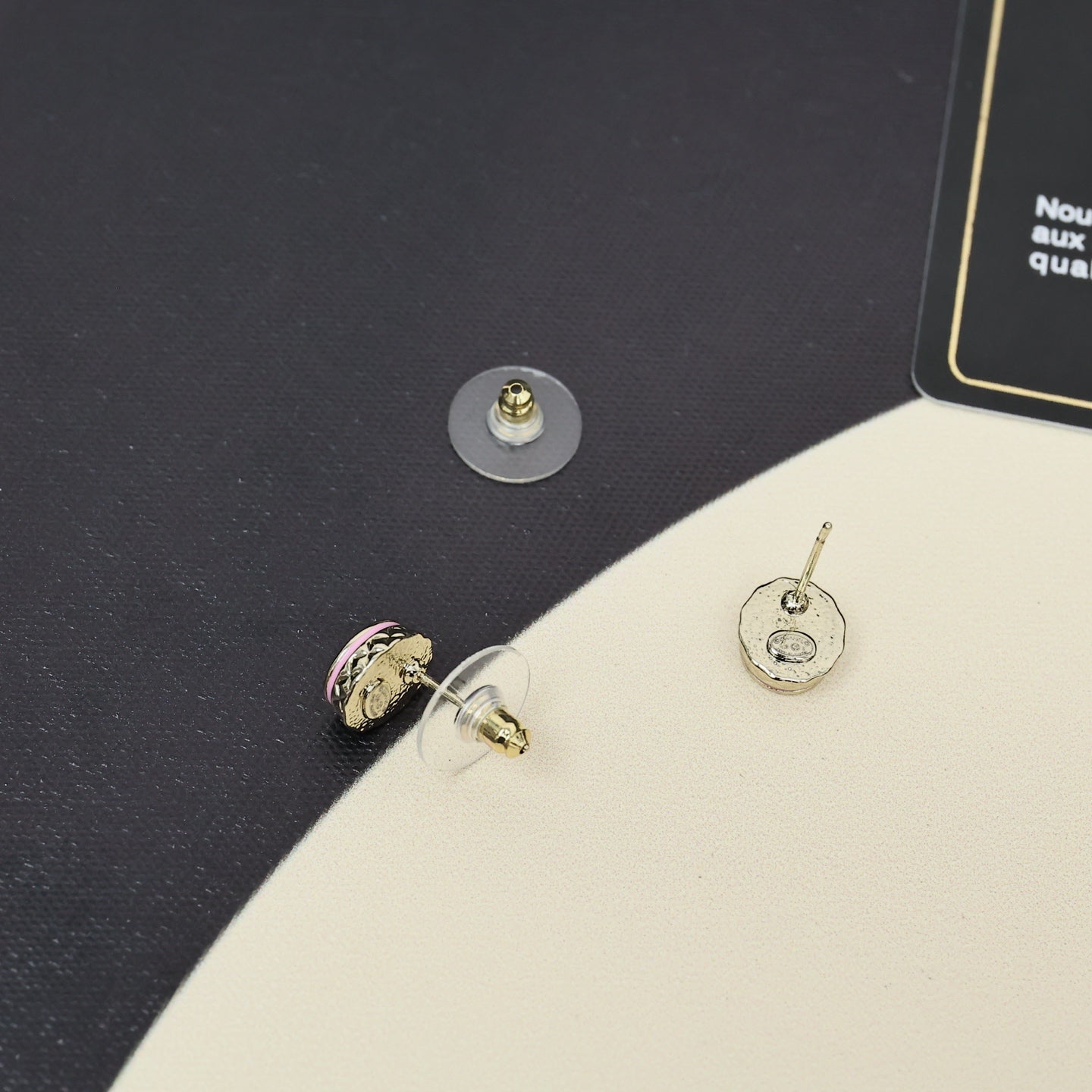 Gold-tone stud earrings with circular CC logo and pink enamel accents.
