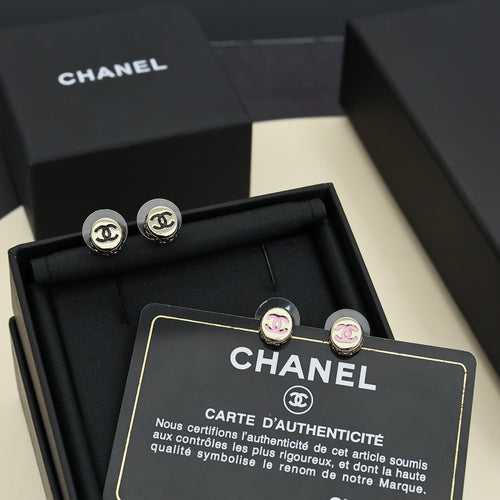Gold-tone stud earrings in a black gift box with circular CC logo details.