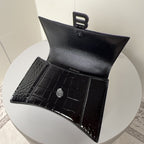 Black croc-texture pouch with button snap and BALENCIAGA lettering inside
