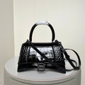 Black croc-texture mini handbag with top handle, flap, and front B buckle
