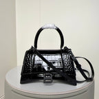 Black croc-texture mini handbag with top handle, flap, and front B buckle