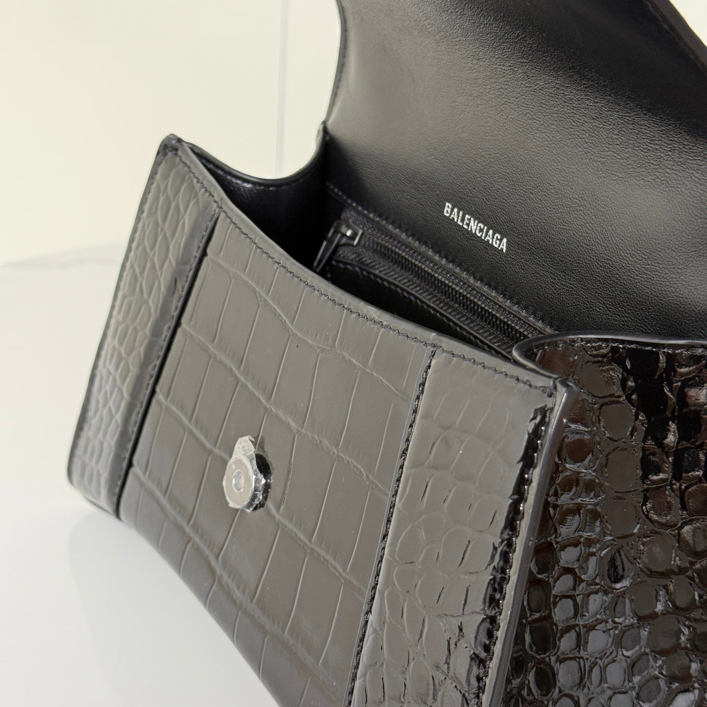 Balenciaga bag interior close-up with BALENCIAGA logo and croc-embossed trim, gray and black