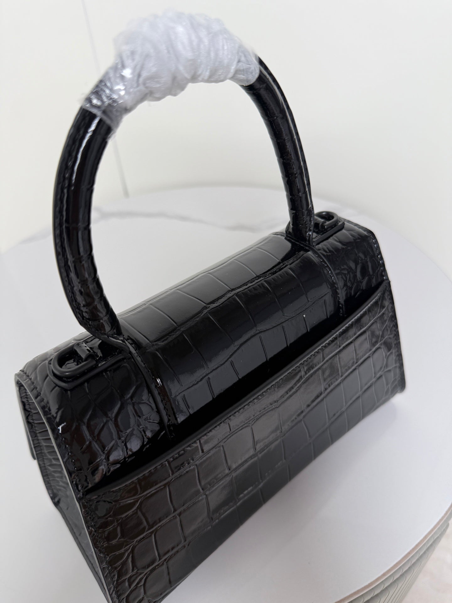 Balenciaga top-handle bag in dark croc-embossed leather, front strap detail and handle