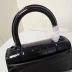 Black glossy croc-texture top handle with B hardware on front flap