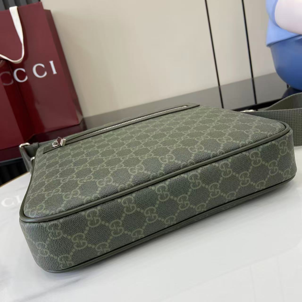 Gucci GG canvas clutch bag with long zip and matching green leather trim