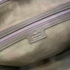 Gucci GG canvas close-up of logo patch and purple zipper trim stitching