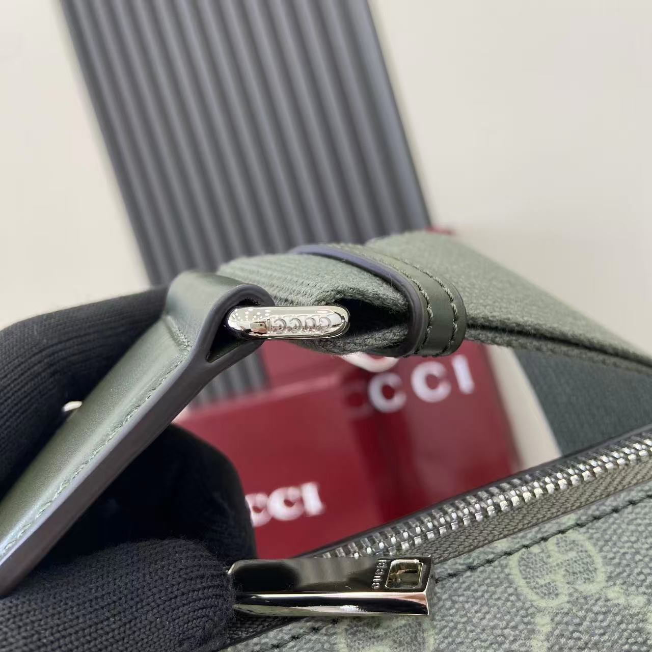 Gucci bag strap and zipper pull, green leather with metal hardware and logo plaque