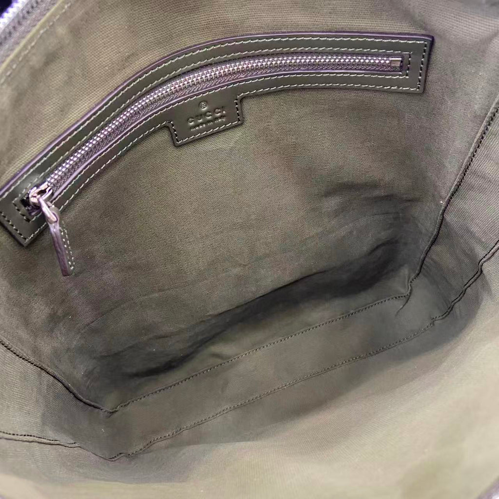 Gucci bag interior pocket close-up with stitched leather trim and zipper edge