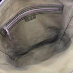Gucci bag interior pocket close-up with stitched leather trim and zipper edge
