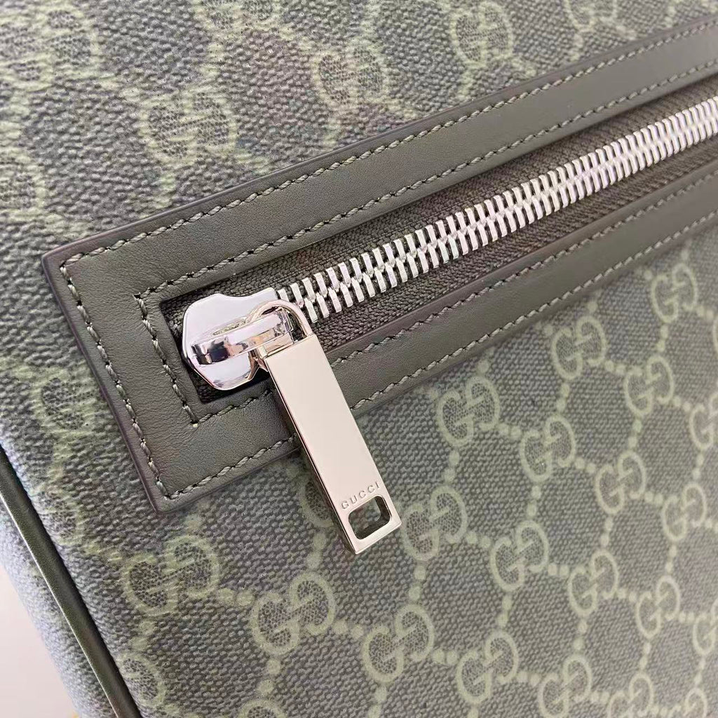 Gucci GG canvas bag close-up of silver-tone zipper pull and leather trim