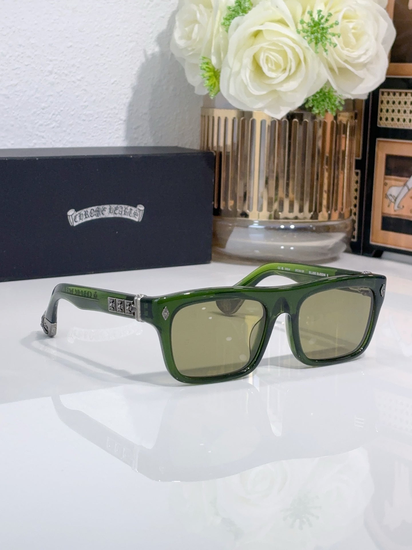 Chrome glasses with green frames and light tan lenses, wide rectangular eyeglasses