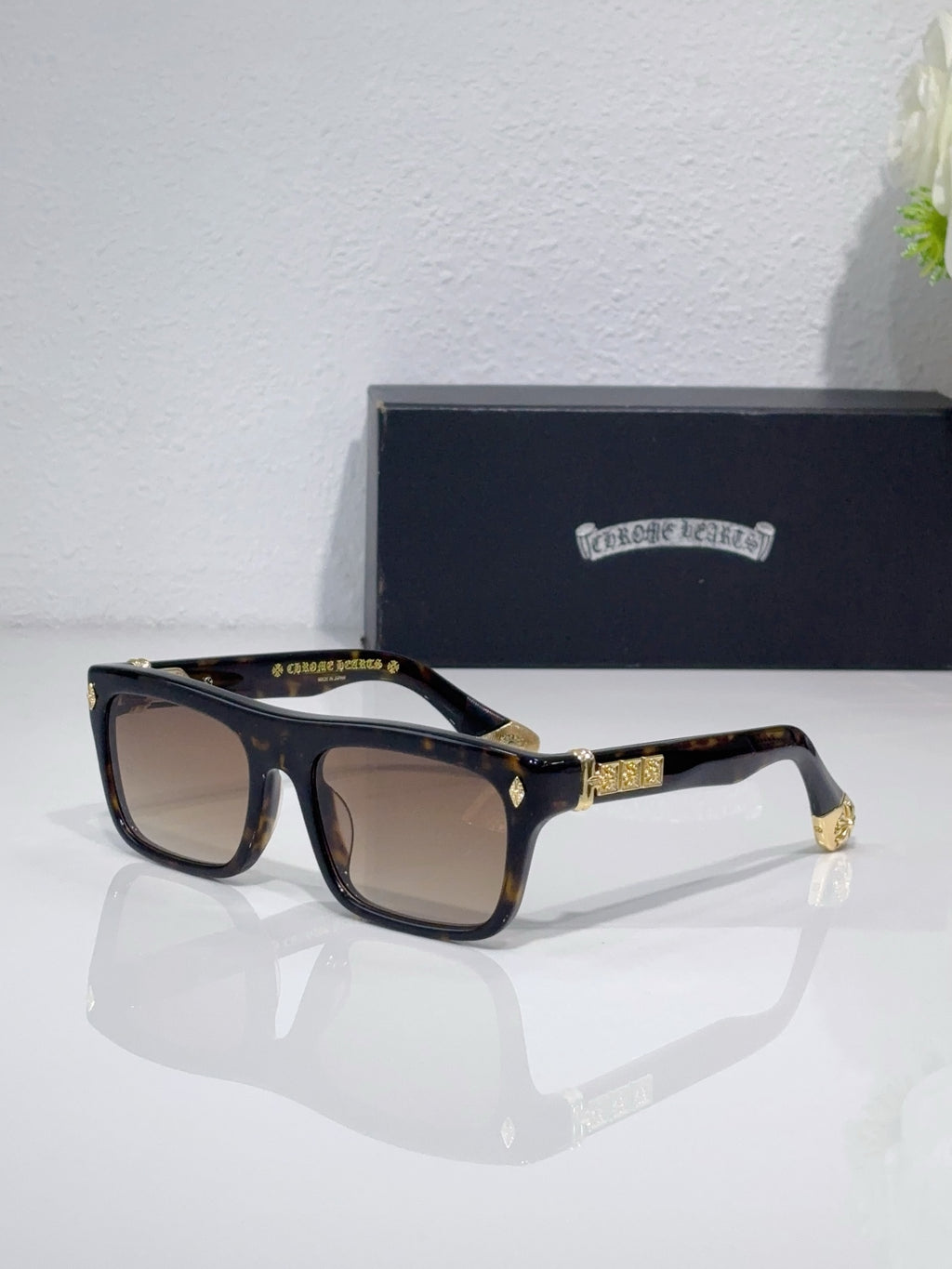 Chrome glasses with dark frames and light brown lenses, gold temple accents