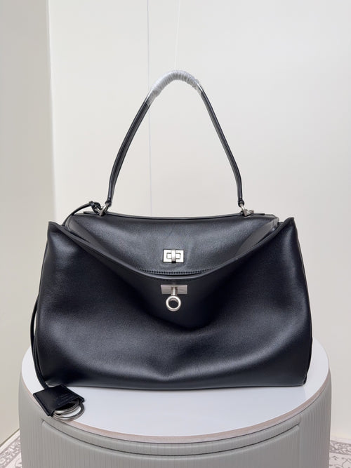Balenciaga black leather handbag with top handles and front flap