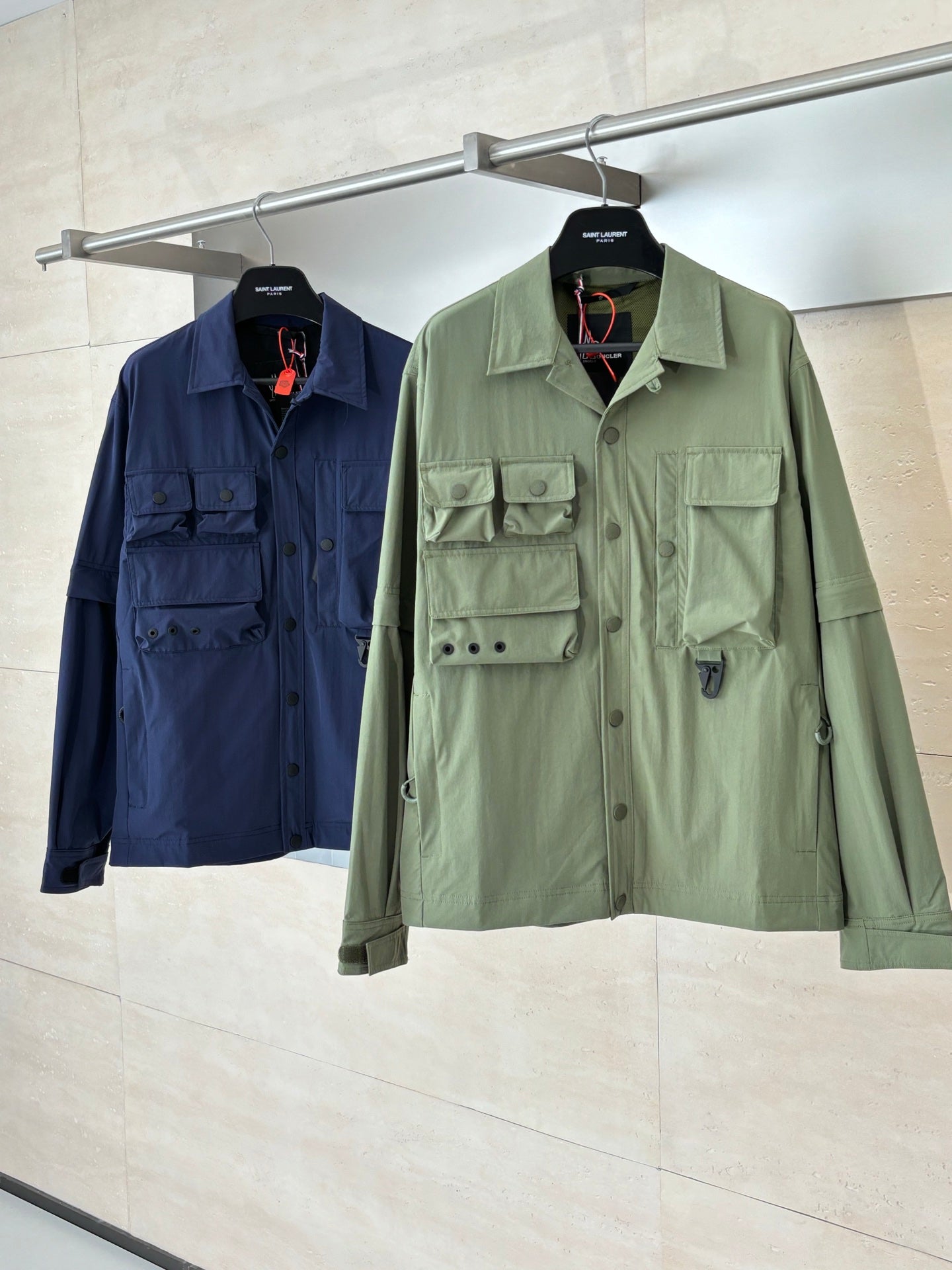 Moncler long jackets on hangers: olive green and dark blue, button front