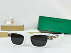 White sunglasses with dark lenses and gold-tone metal hinges and bridge details.