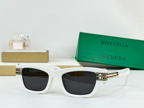 White sunglasses with dark lenses and gold-tone metal hinges and bridge details.