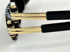Sunglasses temple close-up with gold-tone metal bar and black end caps.