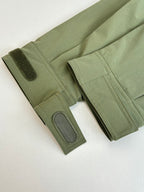 Long olive coat sleeves with textured cuffs and snap pocket detail