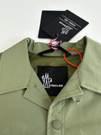 Moncler long jacket neckline close-up with logo lining and hanging care tag