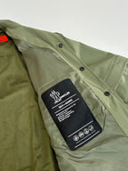 Moncler long jacket olive green with care label on button placket close-up