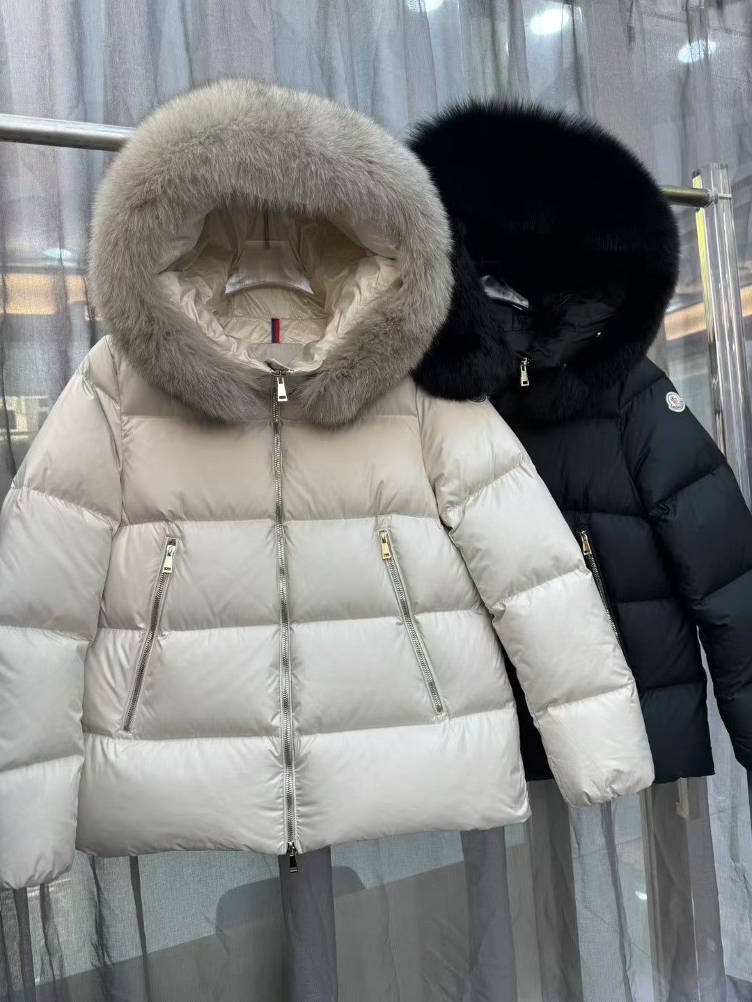 Moncler long puffer jacket with cream fur hood and zip front, side zip pockets
