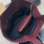 Maroon handbag open interior with visible pocket and maroon zip pouch